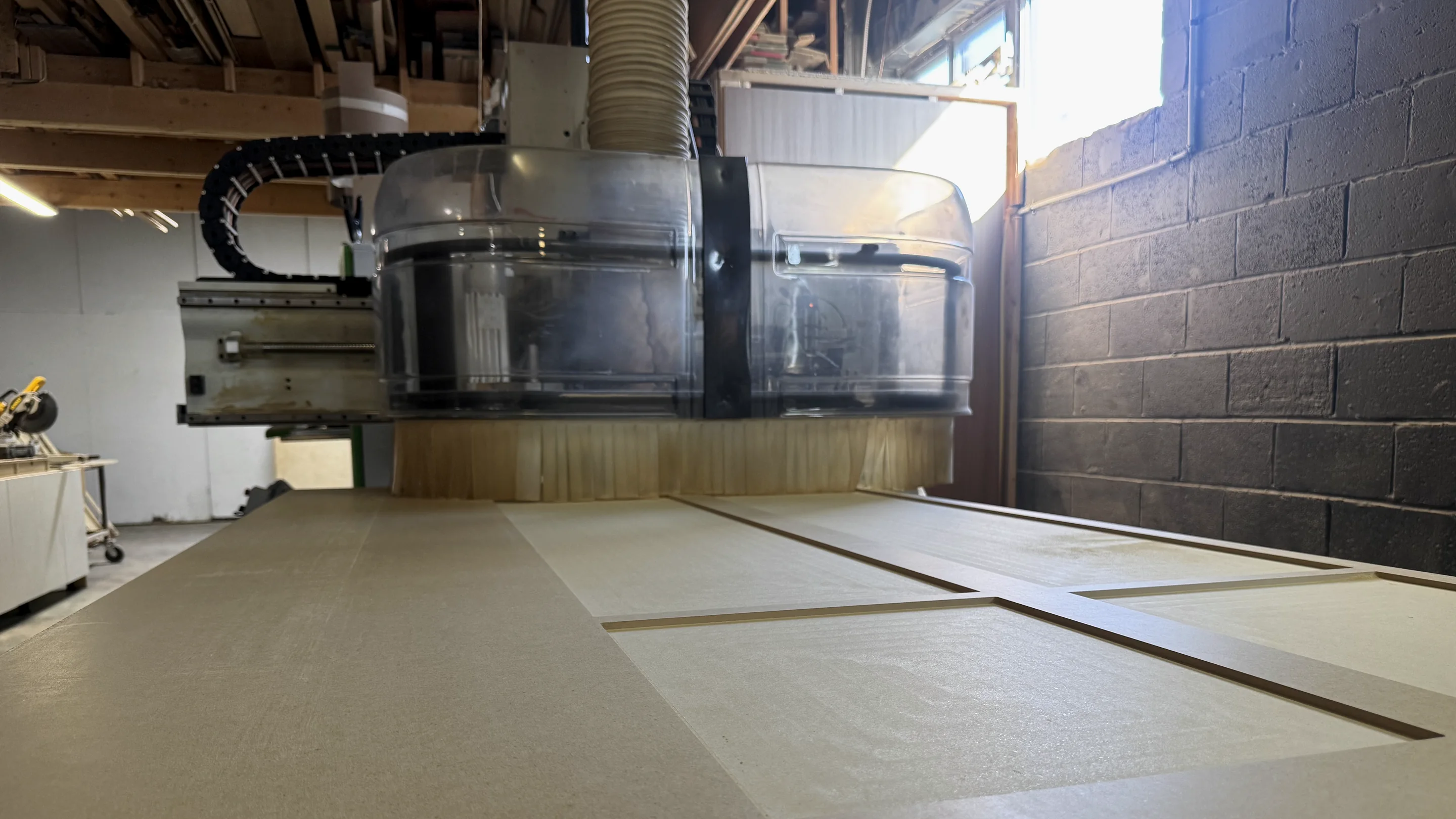 CNC machinery manufacturing a custom millwork component at Luxury Carpentry